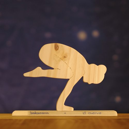 Postura de yoga el cuervo, en madera sobre base con nombre en sánscrito y en castellano
